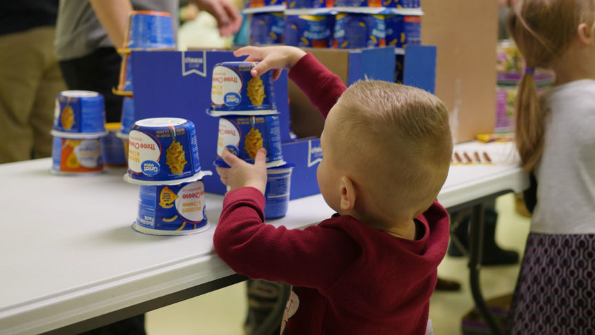 little boy stacking food